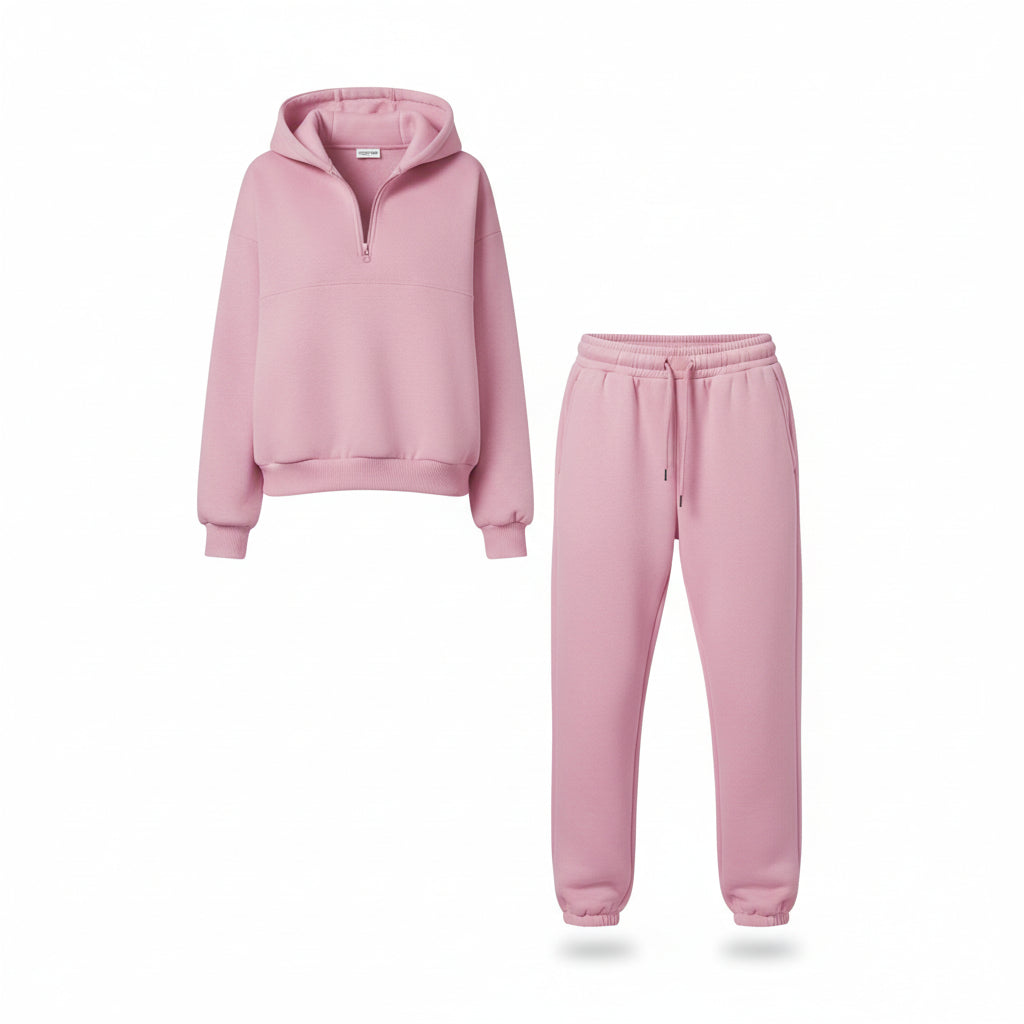 Person wearing a pink tracksuit standing on a sidewalk.