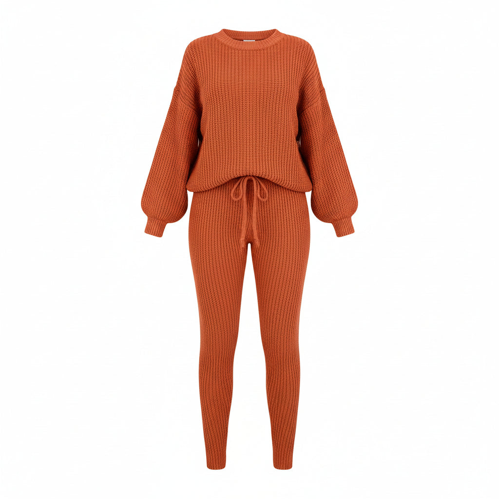 Person wearing an orange knit outfit with a beige sofa and white curtains in the background
