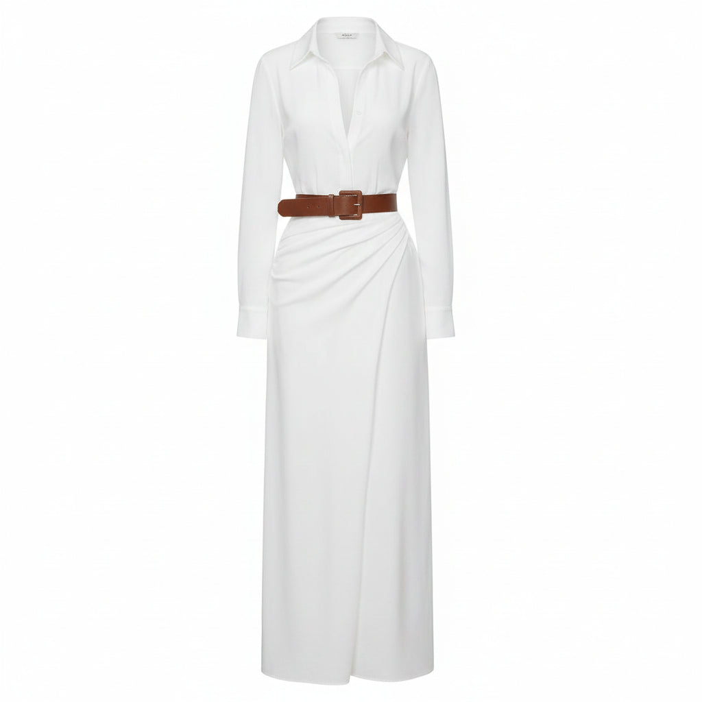 Woman wearing a white dress with a brown belt and holding a woven bag against a plain background
