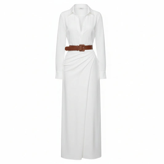Woman wearing a white dress with a brown belt and holding a woven bag against a plain background