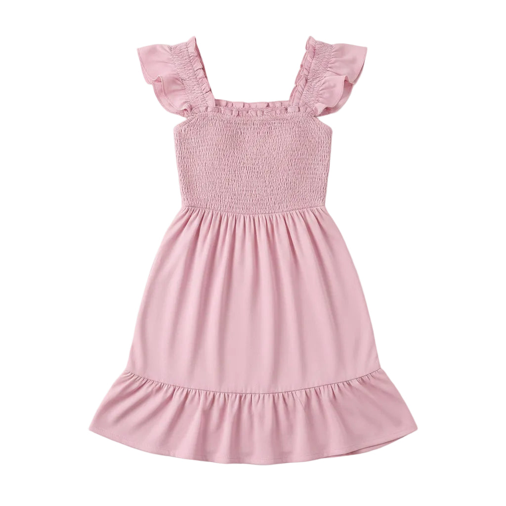 Woman wearing a pink dress against a plain background