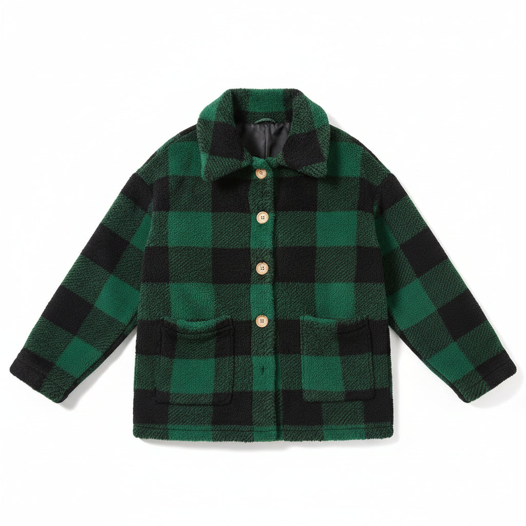 Woman wearing a green and black checkered jacket on a city street.
