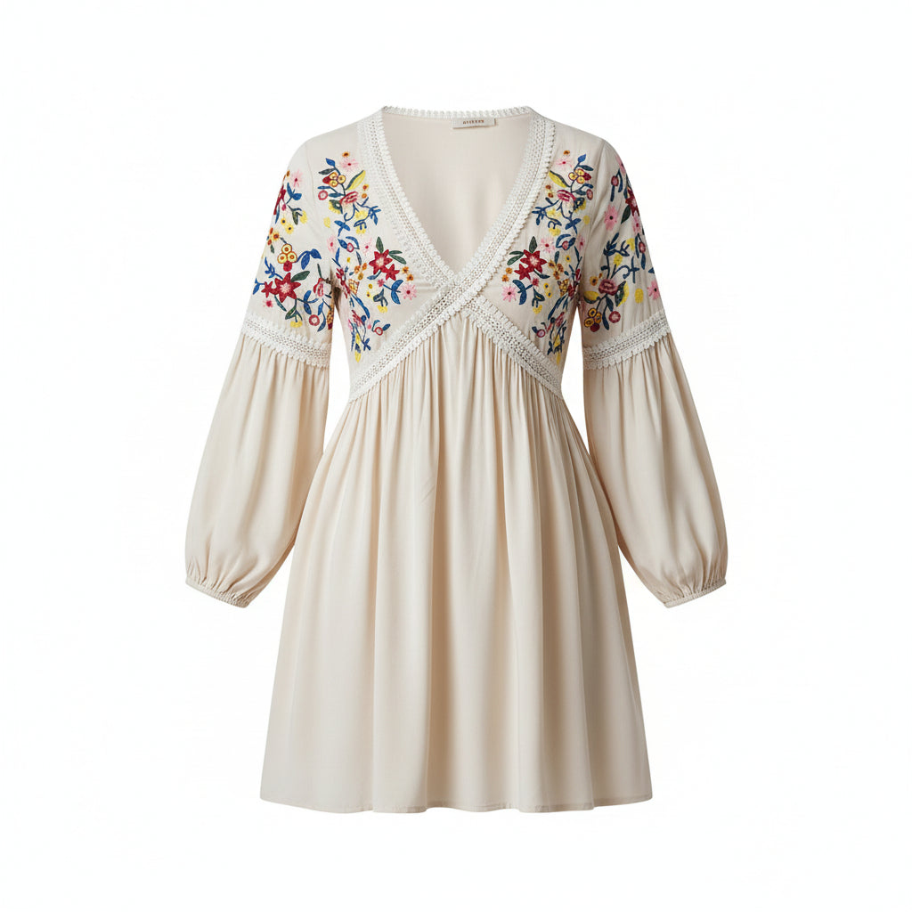 Woman wearing a white dress with colorful embroidery against a gray background