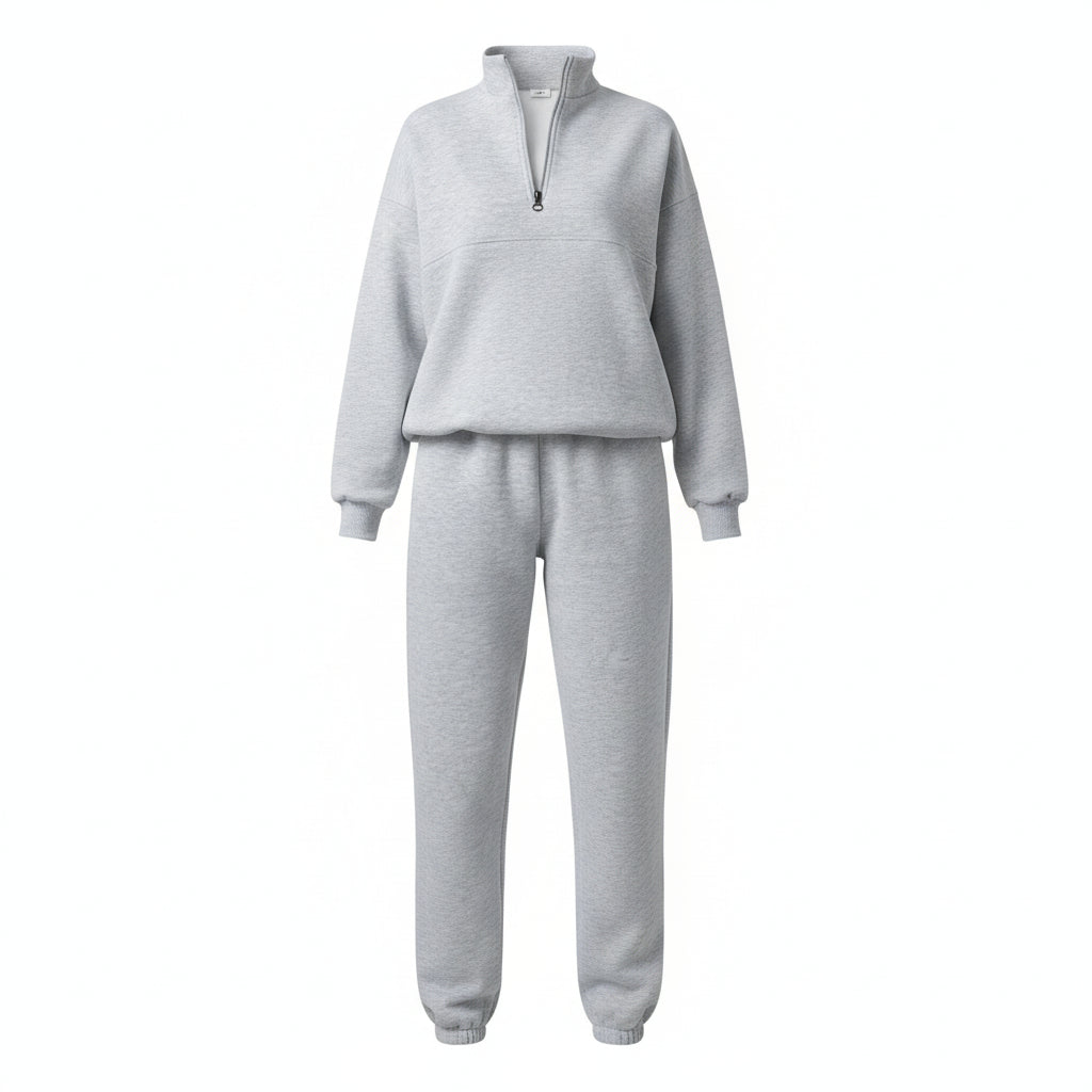 Person wearing a gray tracksuit holding a coffee cup in an elevator.