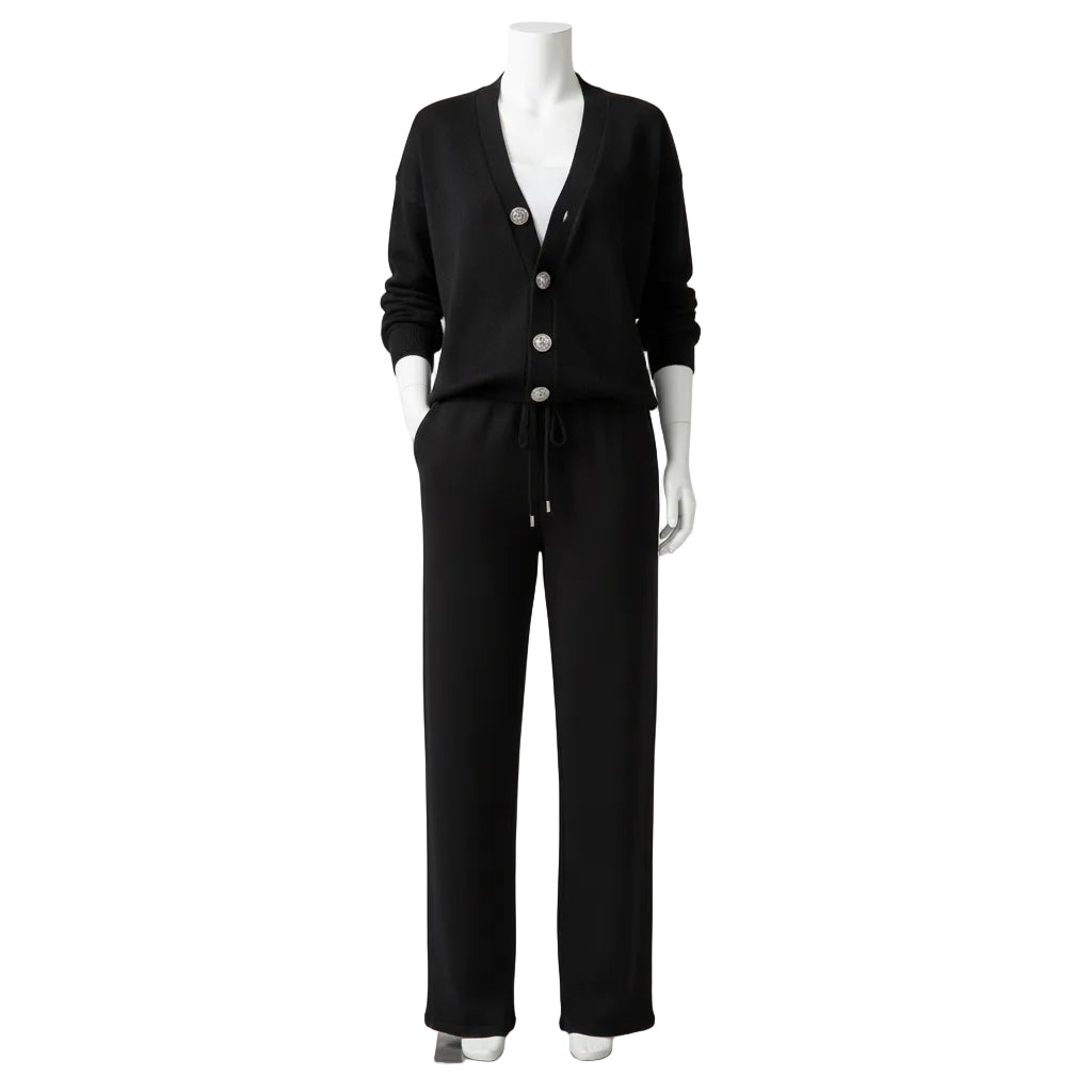 Person wearing a black outfit with white buttons in a fitting room.