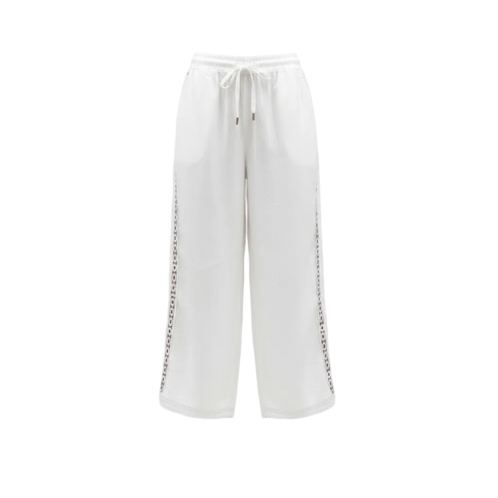 White pants with decorative trim worn by a person on a white background