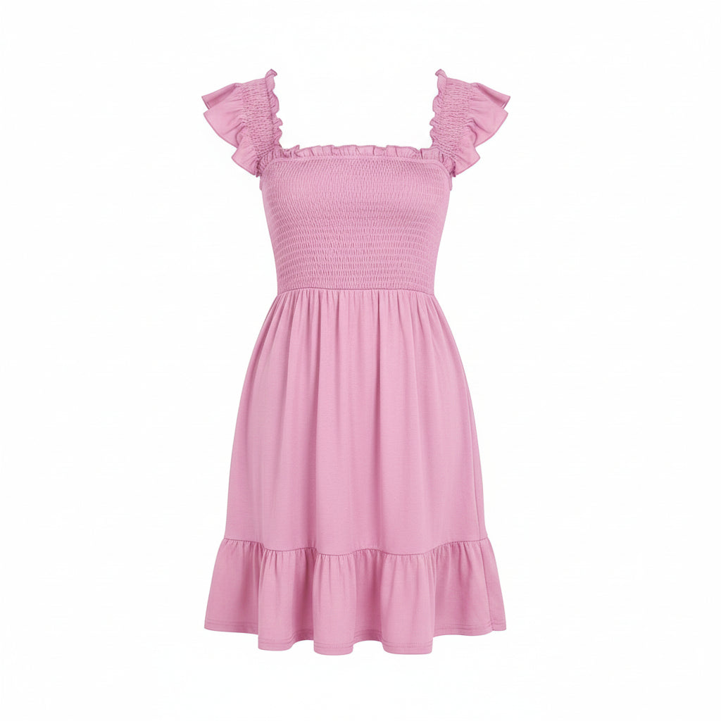 Woman wearing a pink dress with ruffled sleeves against a gray background