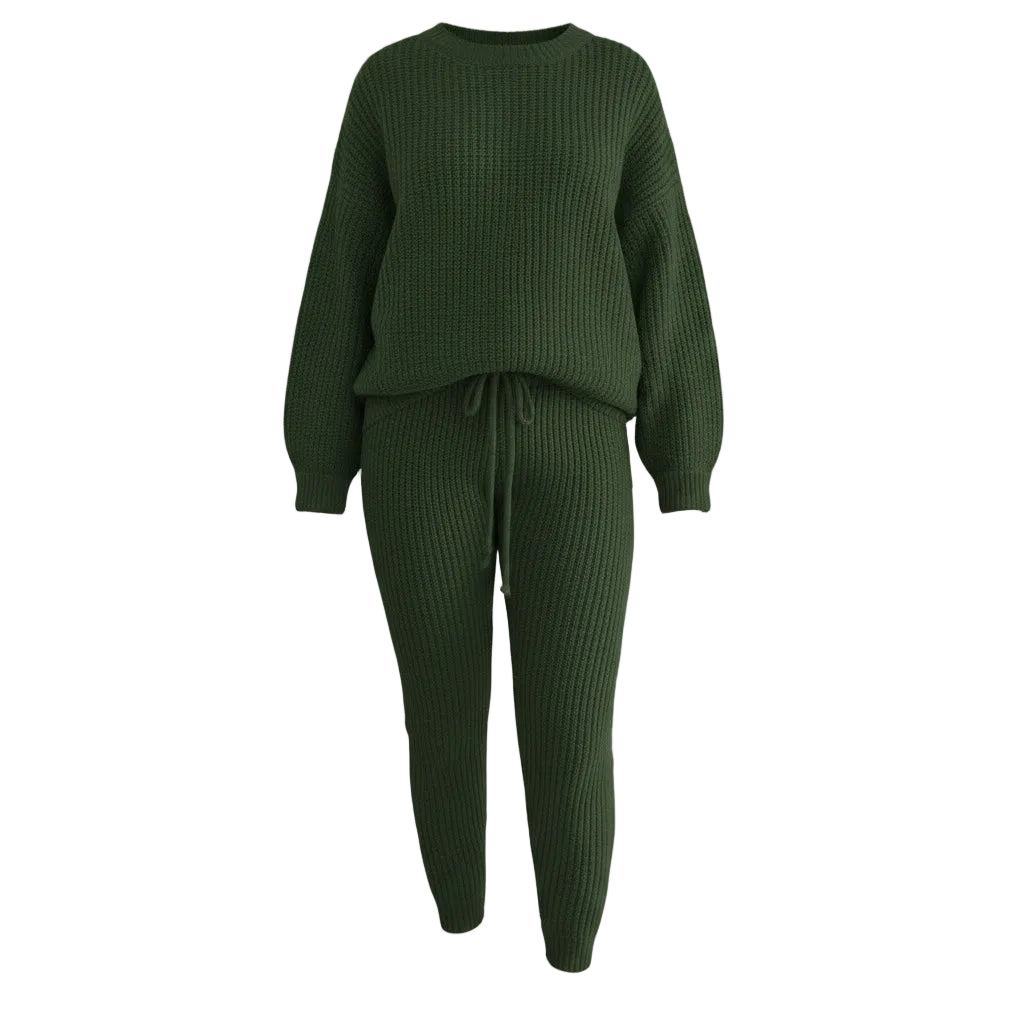 Person wearing a green ribbed sweater and pants set, holding a brown handbag indoors.