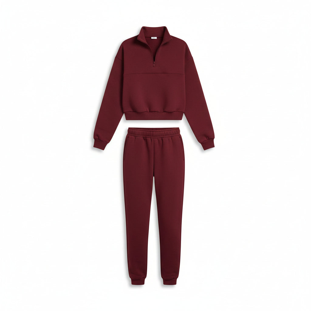Maroon tracksuit worn by a person against a neutral background